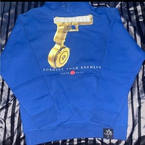 Blue hoodie with golden gun